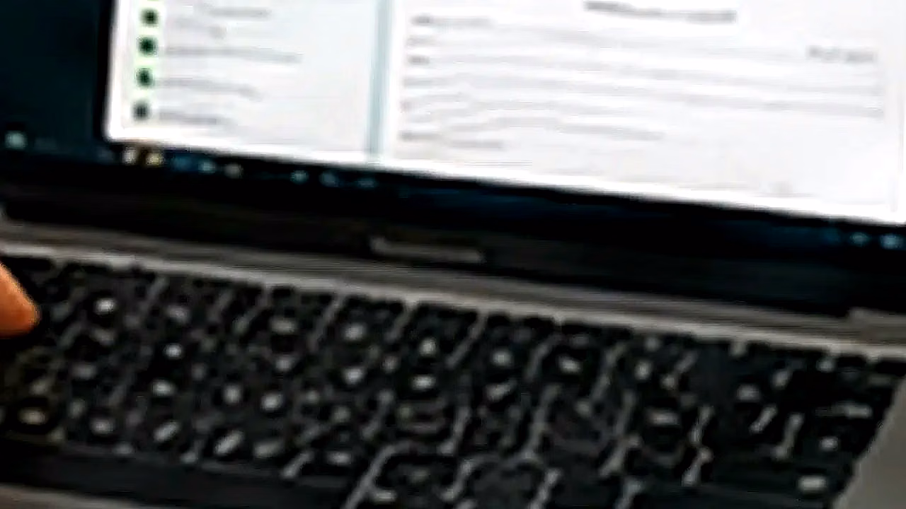 Persona usando WhatsApp Web con laptop y celular en Perú